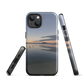 Phone case with tranquil lake scene at sunrise and distant hills.