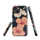Phone case with coral hibiscus flowers and ivory blooms on dark background