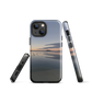 Phone case with tranquil lake scene at sunrise and distant hills.