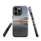 Phone case with tranquil lake scene at sunrise and distant hills.