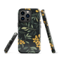 NZ Kowhai phone case with native yellow floral and green leaves on black background by designer Ben Hart.