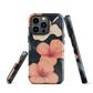 Phone case with coral hibiscus flowers and ivory blooms on dark background