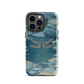 Nature-inspired phone case featuring a dragonfly over calm water with blue and green forest tones.