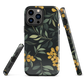 NZ Kowhai phone case with native yellow floral and green leaves on black background by designer Ben Hart.