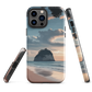 Phone case with Cathedral Cove beach and sunset scene, featuring soft skies and sea stack