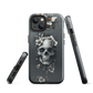 Gothic phone case with a floral skull design in grey tones, featuring white blossoms and dark detailing.