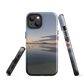 Phone case with tranquil lake scene at sunrise and distant hills.