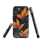 Phone case with bold orange bird of paradise flowers on dark background.