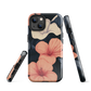 Phone case with coral hibiscus flowers and ivory blooms on dark background