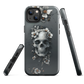 Gothic phone case with a floral skull design in grey tones, featuring white blossoms and dark detailing.