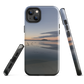 Phone case with tranquil lake scene at sunrise and distant hills.