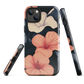 Phone case with coral hibiscus flowers and ivory blooms on dark background