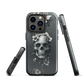 Gothic phone case with a floral skull design in grey tones, featuring white blossoms and dark detailing.