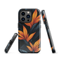 Phone case with bold orange bird of paradise flowers on dark background.