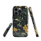 NZ Kowhai phone case with native yellow floral and green leaves on black background by designer Ben Hart.