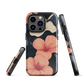 Phone case with coral hibiscus flowers and ivory blooms on dark background