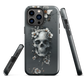 Gothic phone case with a floral skull design in grey tones, featuring white blossoms and dark detailing.
