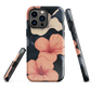 Phone case with coral hibiscus flowers and ivory blooms on dark background