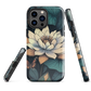 Phone case with ivory water lily, green leaves, and butterfly accents on dark background