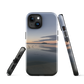 Phone case with tranquil lake scene at sunrise and distant hills.