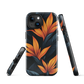 Phone case with bold orange bird of paradise flowers on dark background.