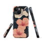 Phone case with coral hibiscus flowers and ivory blooms on dark background