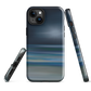 Dark abstract phone case with blue and grey streaks and glossy finish.