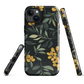 NZ Kowhai phone case with native yellow floral and green leaves on black background by designer Ben Hart.