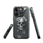Gothic phone case with a floral skull design in grey tones, featuring white blossoms and dark detailing.