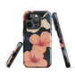 Phone case with coral hibiscus flowers and ivory blooms on dark background