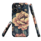 Phone case with vintage-style pink roses and bees on dark background, floral New Zealand artwork.