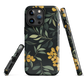NZ Kowhai phone case with native yellow floral and green leaves on black background by designer Ben Hart.