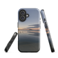 Phone case with tranquil lake scene at sunrise and distant hills.