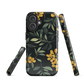 NZ Kowhai phone case with native yellow floral and green leaves on black background by designer Ben Hart.
