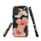 Phone case with coral hibiscus flowers and ivory blooms on dark background