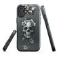 Gothic phone case with a floral skull design in grey tones, featuring white blossoms and dark detailing.