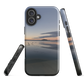 Phone case with tranquil lake scene at sunrise and distant hills.