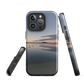 Phone case with tranquil lake scene at sunrise and distant hills.