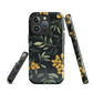NZ Kowhai phone case with native yellow floral and green leaves on black background by designer Ben Hart.