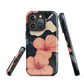 Phone case with coral hibiscus flowers and ivory blooms on dark background
