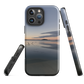 Phone case with tranquil lake scene at sunrise and distant hills.