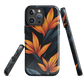 Phone case with bold orange bird of paradise flowers on dark background.