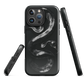 Phone case with detailed black python design on dark background.