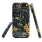 NZ Kowhai phone case with native yellow floral and green leaves on black background by designer Ben Hart.