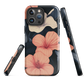 Phone case with coral hibiscus flowers and ivory blooms on dark background
