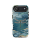 Nature-inspired phone case featuring a dragonfly over calm water with blue and green forest tones.