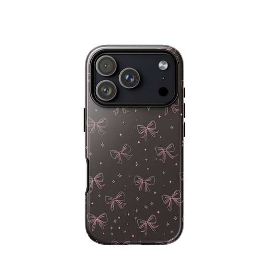 Midnight Bow seamless repeat pattern — pink hand-drawn ribbon bows and sparkle stars on a black background