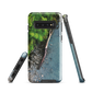 Resting Place phone case with aerial artwork of river rocks, green bush, and driftwood in a New Zealand stream.