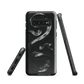 Phone case with detailed black python design on dark background.