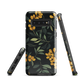 NZ Kowhai phone case with native yellow floral and green leaves on black background by designer Ben Hart.